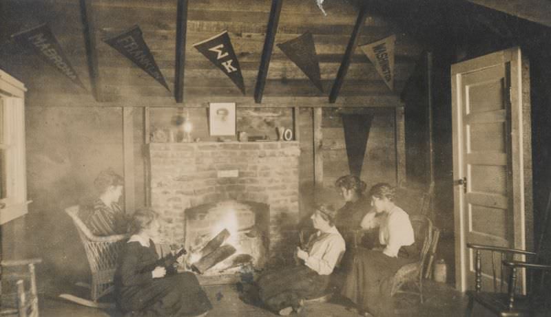 Women gathered around a fireplace playing musical instruments