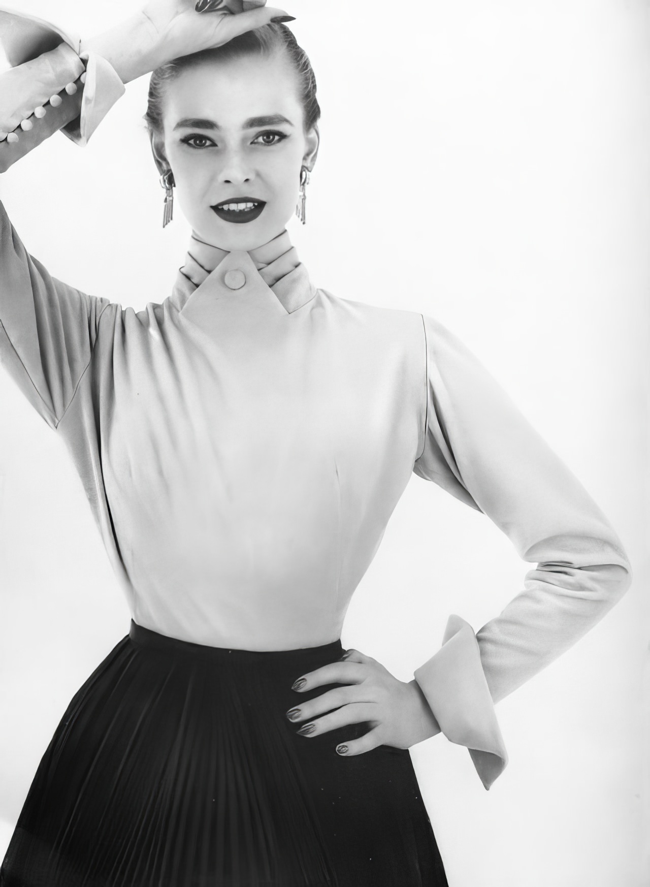 Susan Abraham in a back-buttoning blouse in yellow velours, 1953.
