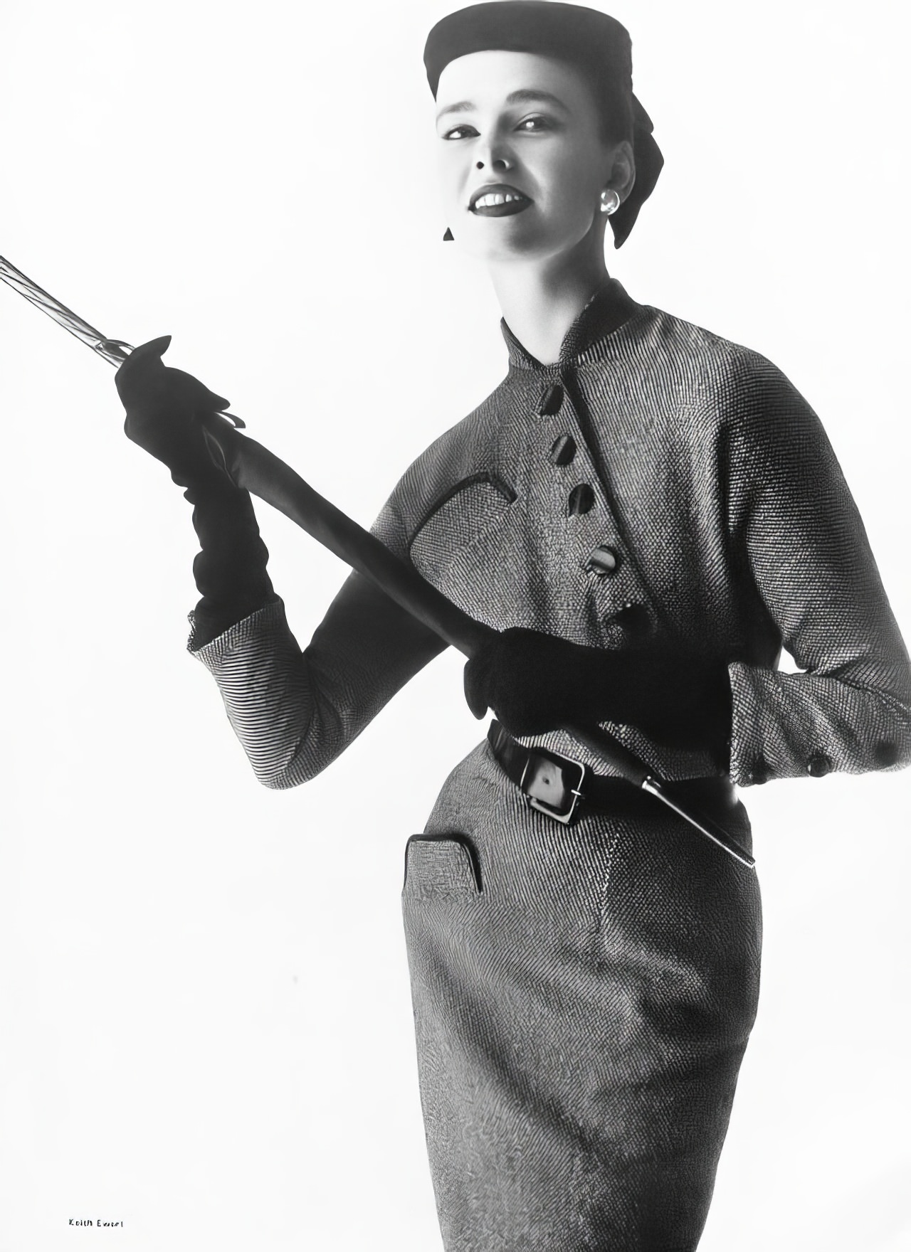 Susan Abraham in a black-and-white tweed dress, 1953.