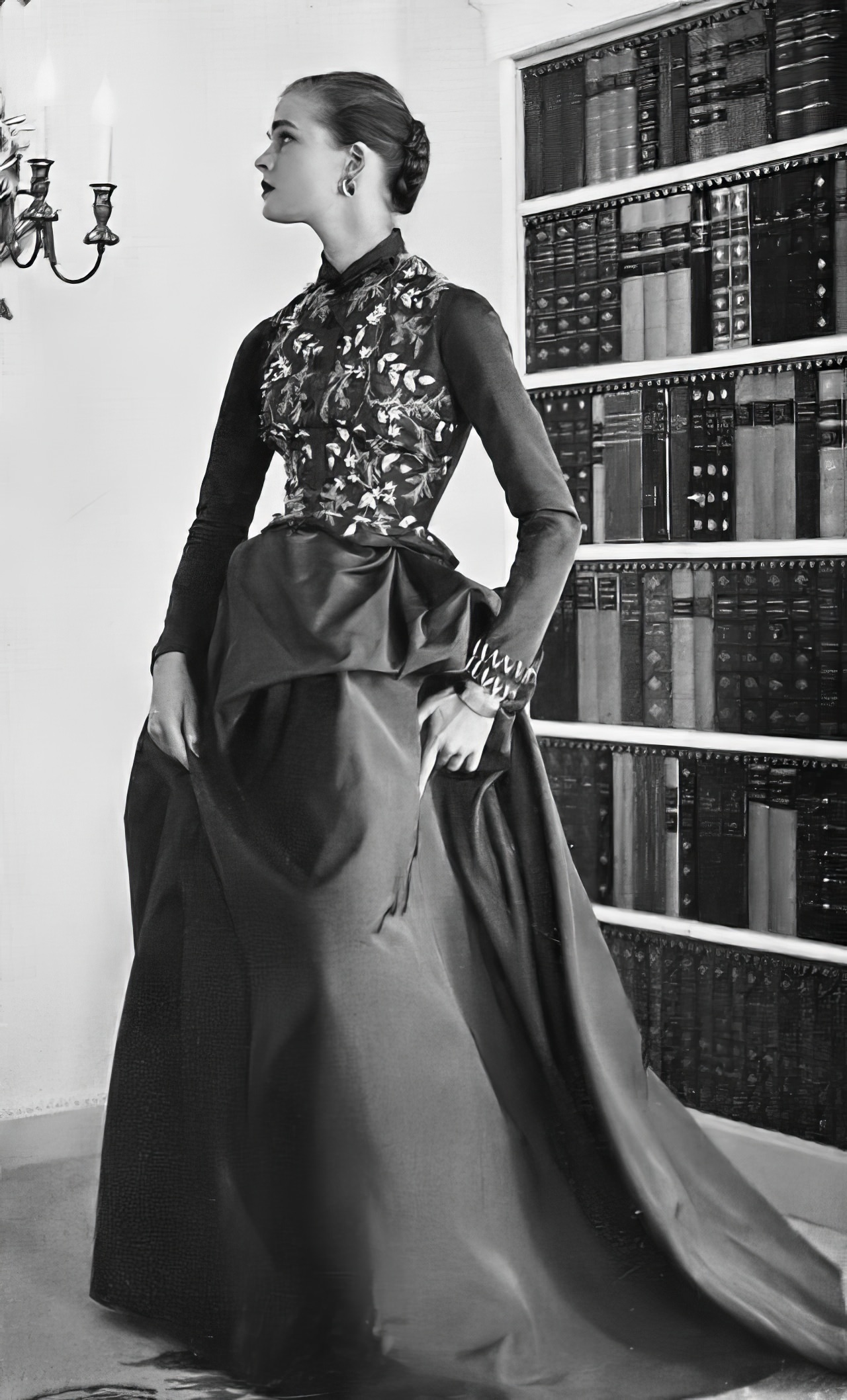 Susan Abraham in a mole-brown backswept faille gown, 1953.