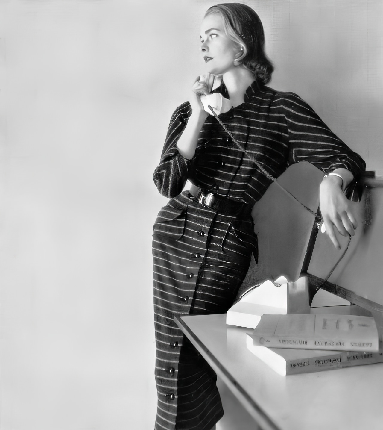 Susan Abraham in a button-through dress in gun-metal gray jersey with dove-gray stripes, 1951.