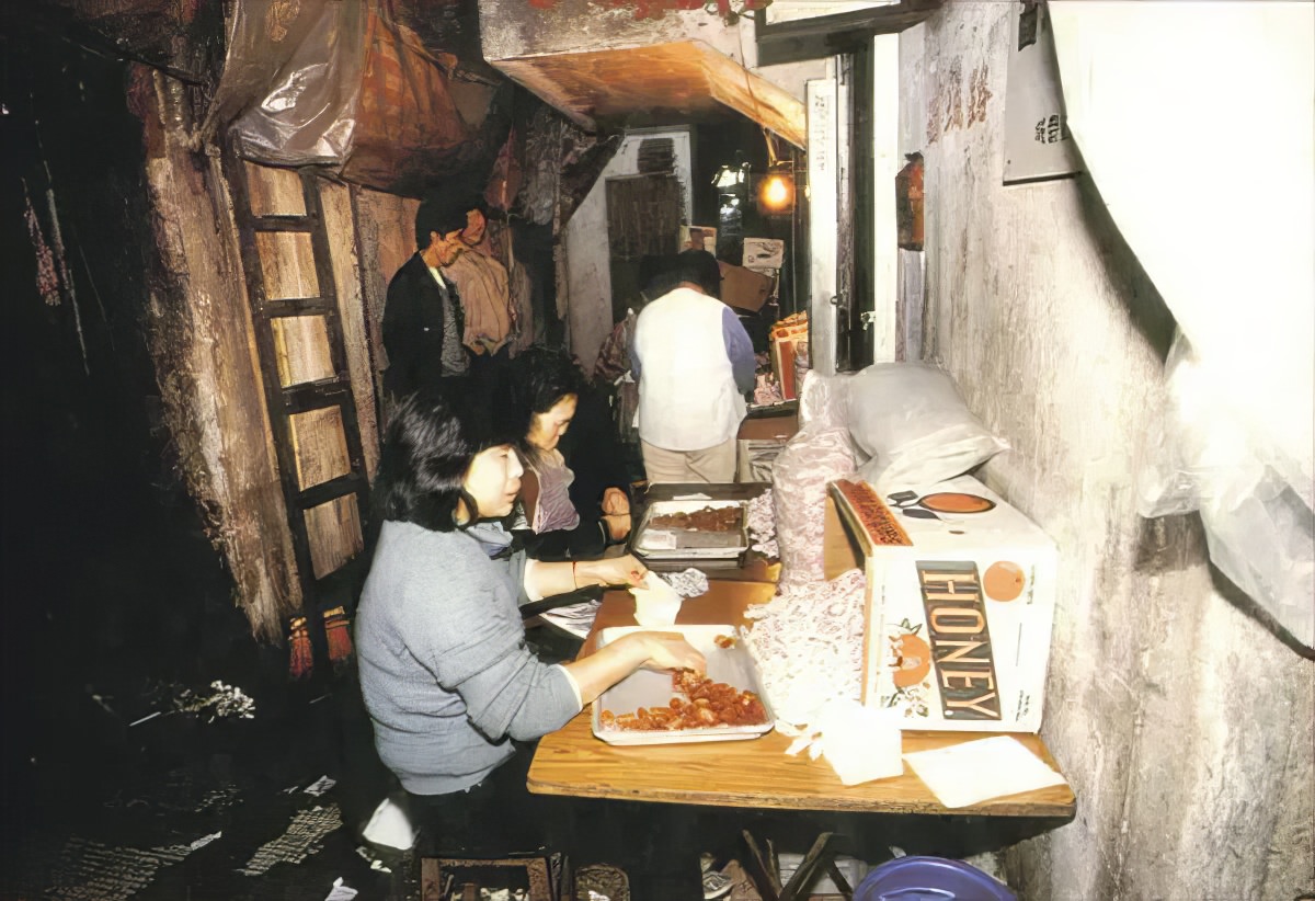 Women making food in Kowloon Walled City. The city was known for its food production, as well as its plastics and textile manufacturing.