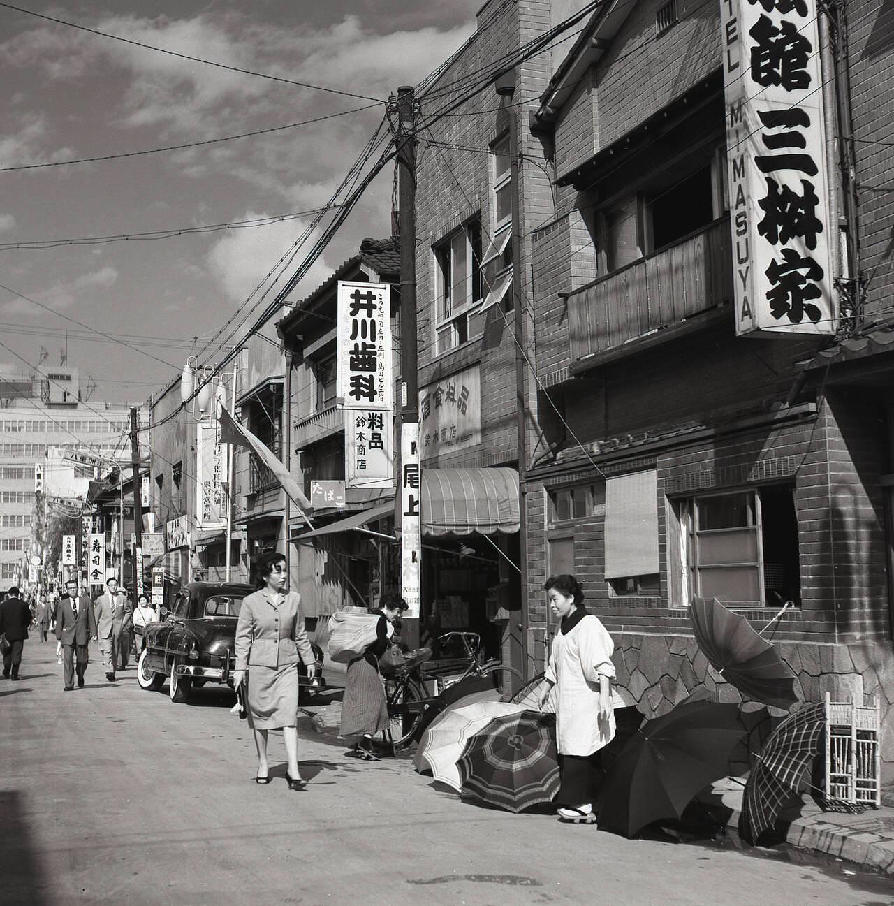 A female Japanese street trader selling umbrellas in Tokyo, 1950s.