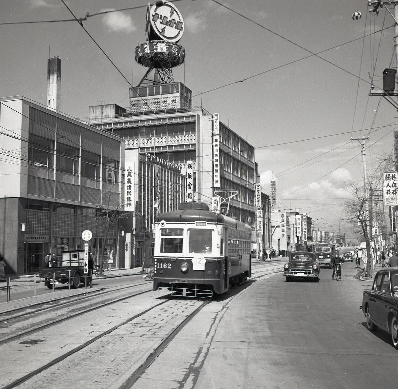 A street scene showing public transport and buildings in Tokyo, 1950s.