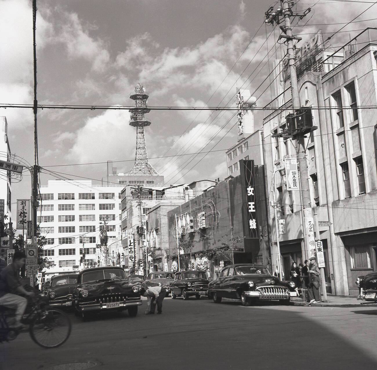 A street in Tokyo with parked cars, 1950s.