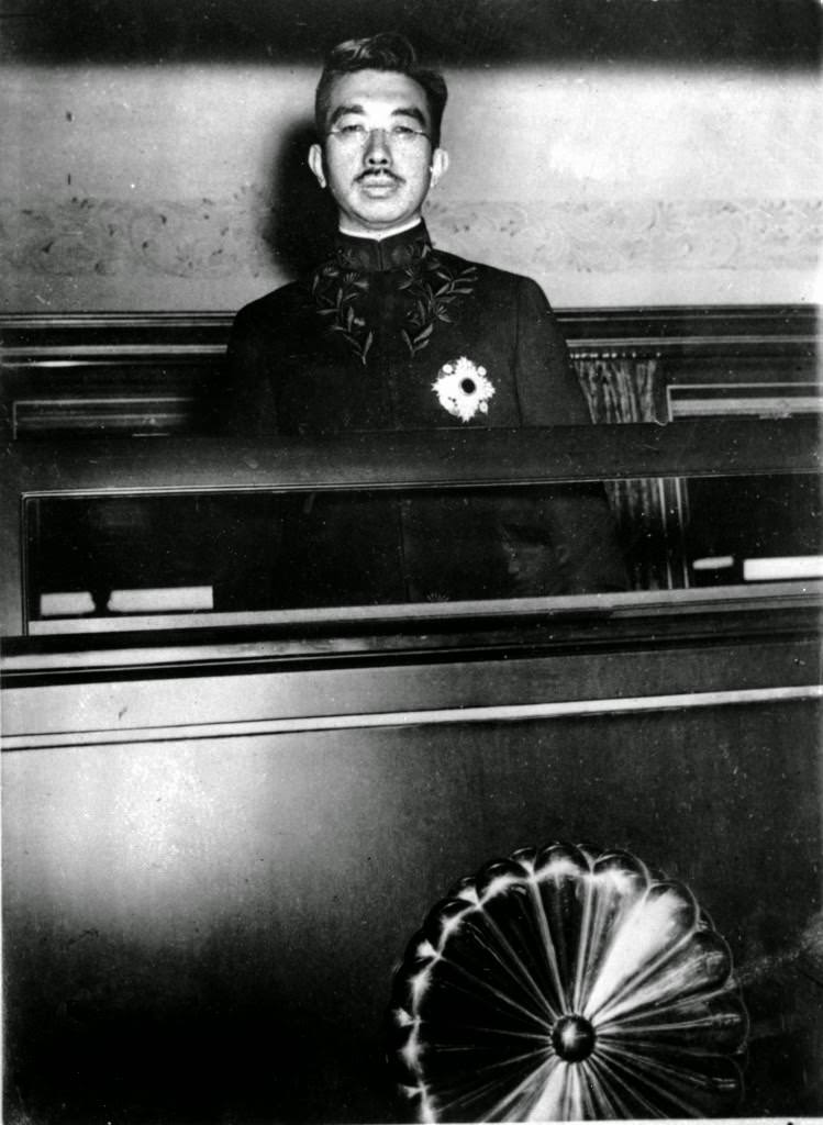 Japanese Emperor Hirohito peers from a window of his special railway car in Tokyo, 1945.
