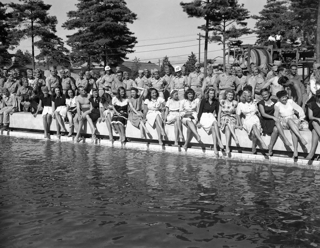 Show girls from the Mikado theater in Tokyo pose on the side of a swimming pool at a new American air base at Yokota, Japan, 1946.