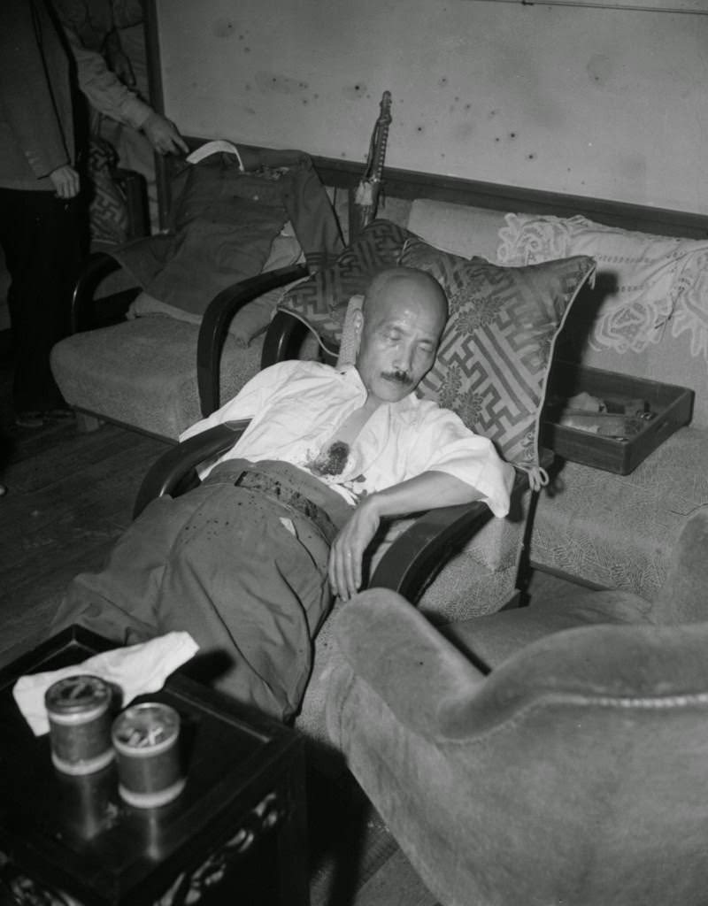 Gen. Hideki Tojo, former Japanese premier, lies semi-conscious in a chair after he shot himself, 1945.