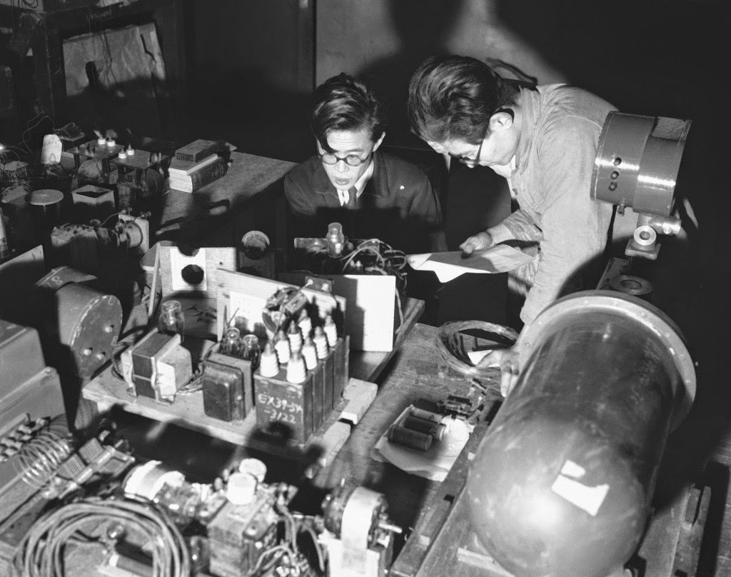 A group of Japanese scientist under the leadership of Dr. Yoshio Nishina is working on the continuous measurement of cosmic ray intensity, measuring the mass of the meson, one of the elementary particles of atomic nucleus. Assistant checks over the Geiger-Muller counter at laboratory in Tokyo, 1949.
