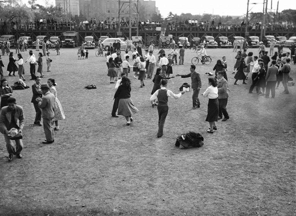 The Virginia reel, a favorite American folk dance, is something new for the Japanese, dancing in Hibiya Park, Tokyo, 1949.