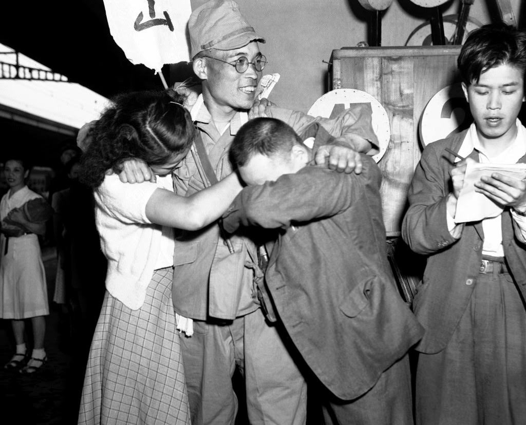 Family members greet each other as a small group of the first batch of repatriates from Russian held territory who arrived back in Japan aboard the Takasago Maru arrived at Shinagawa station a few miles from Tokyo, 1949.