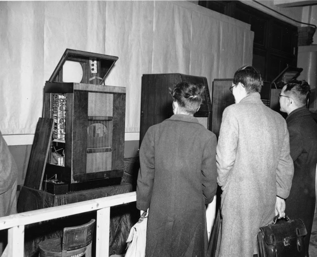Visitors to the television demonstration at the studios of the Japanese Broadcasting Company wait for the show to appear on the screen of one on the receivers, in Tokyo, 1949.