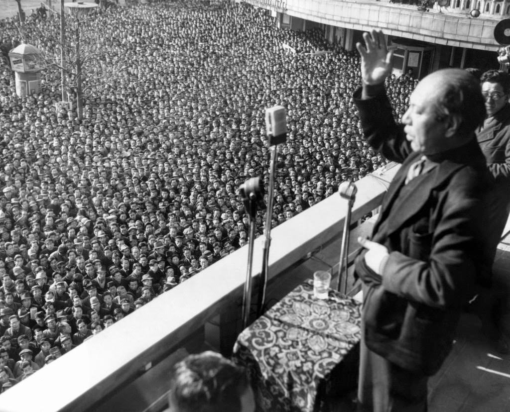 Kyuichi Tokuda, Secretary General of the Communist Party in Tokyo, gestures as he thanks the huge crowd which gathered outside the Asahi newspaper office in Tokyo, 1949.