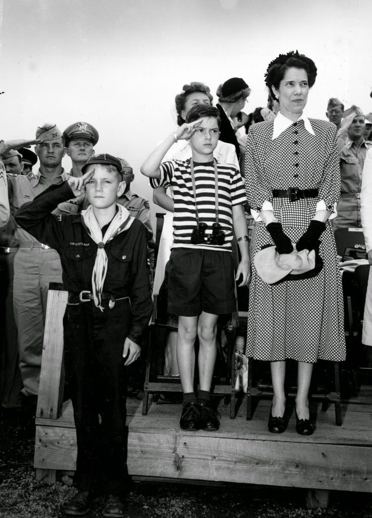 Arthur MacArthur, son of Allied Supreme Commander in Japan, General Douglas MacArthur, salutes a military parade past the Imperial Palace Plaza in Tokyo, 1948.