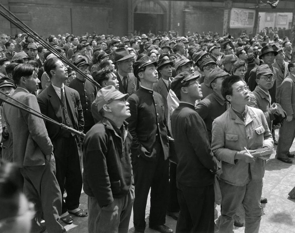 Tokyo citizens turn out to watch the bulletin boards announcing the election results for the candidates for the diet in front of the Asahi Newspaper office in Tokyo, 1947.