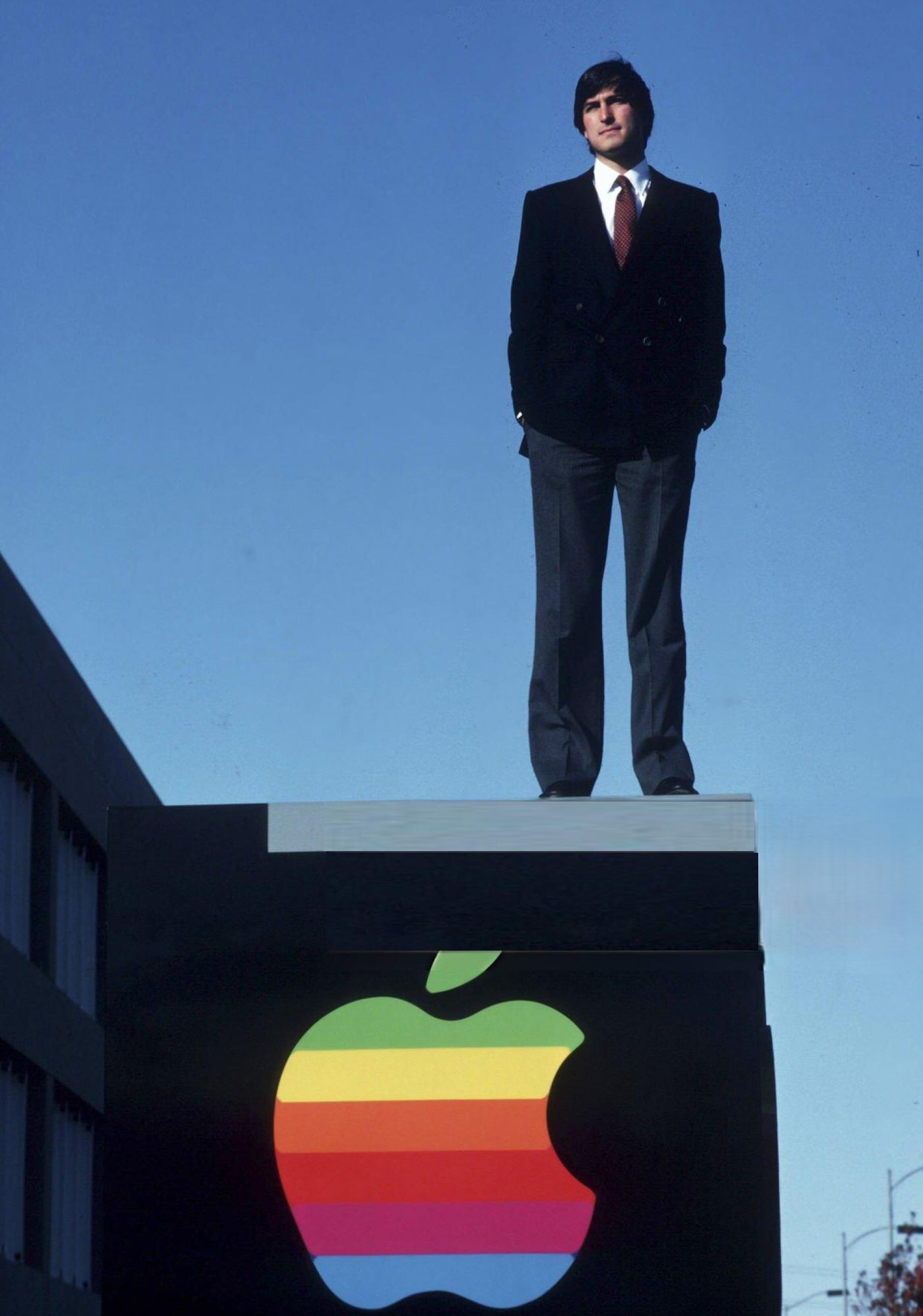 Steve Jobs standing outside of Apple Computer Co., 1982.