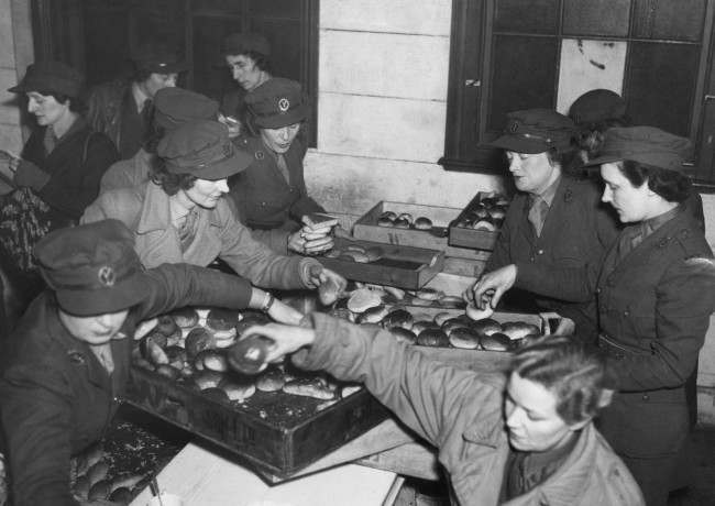 A busy scene in the LegionÂs dockside hut headquarters in London, Feb. 27, 1943 as mobile canteen drivers and helpers load up trays of rolls for the midmorning lunch they serve to dock laborers.