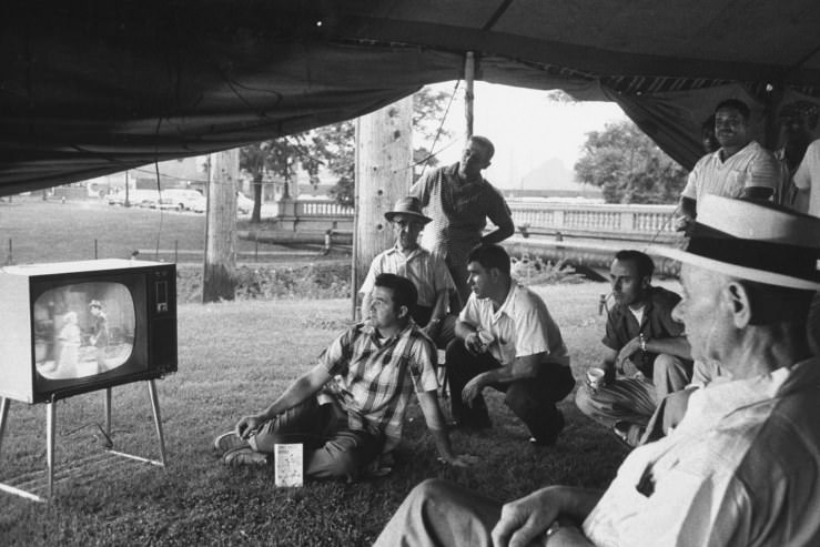 Picketing workers watch TV in a tent outside the gates of a U.S. Steel plant in Gary, Indiana, during a strike in 1959