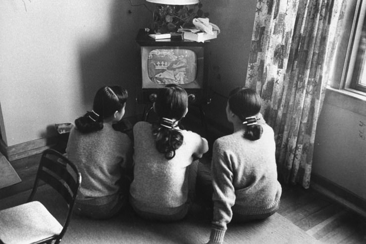 The Kim Sisters — a Korean-born singing trio who had some success in the U.S. in the 1960s — watch television in Chicago in 1960