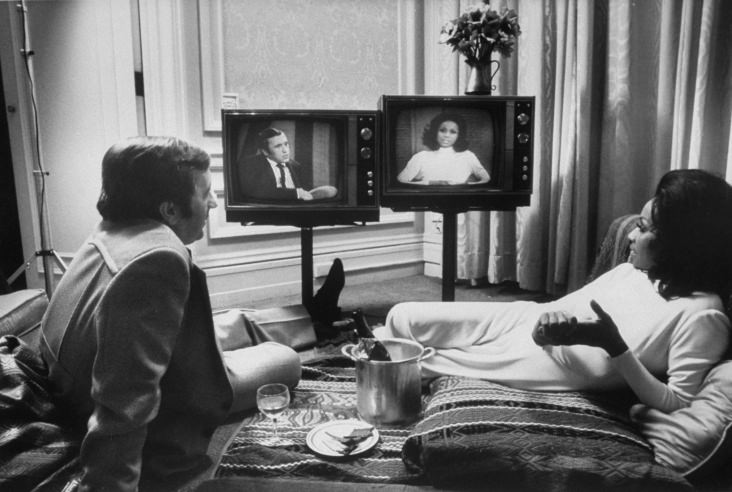 Actress Diahann Carroll and journalist David Frost watch themselves on separate talk shows. Carroll and Frost were engaged for a while, but never married