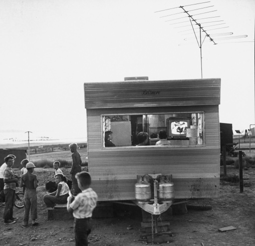 A railroad worker's family watches TV in a trailer at a camp for Southern Pacific employees in Utah in 1957