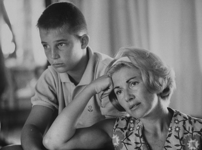 Astronaut Scott Carpenter's wife, Rene, and son, Marc, watch his 1962 orbital flight on TV. Carpenter's was NASA's second manned orbital flight, after John Glenn's, and lasted nearly five hours