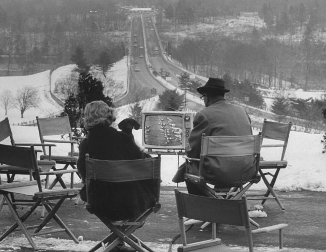 Die-hard New York Giants fans watch a football game on a motel TV, out of the range of the New York-area TV blackout during home games in December 1962