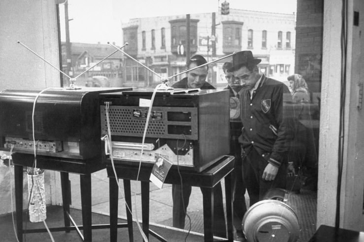 Men gather to watch TV through a store window in Pennsylvania in 1948