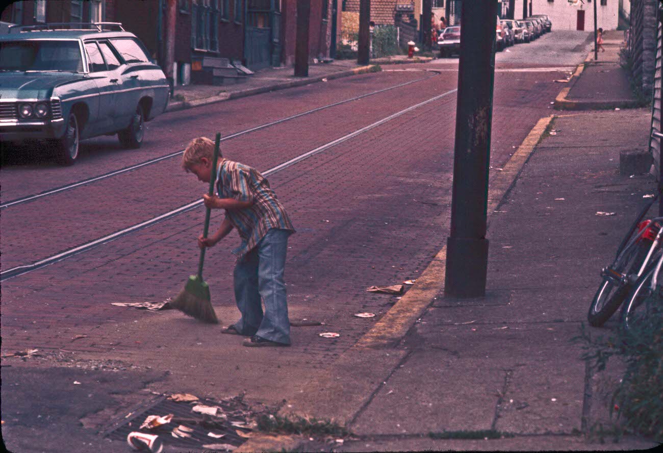 Boy sweeping, 1970s.
