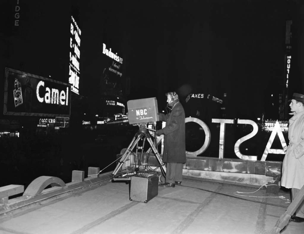 A cameraman recording the New Year's celebration in Times Square, 1946.