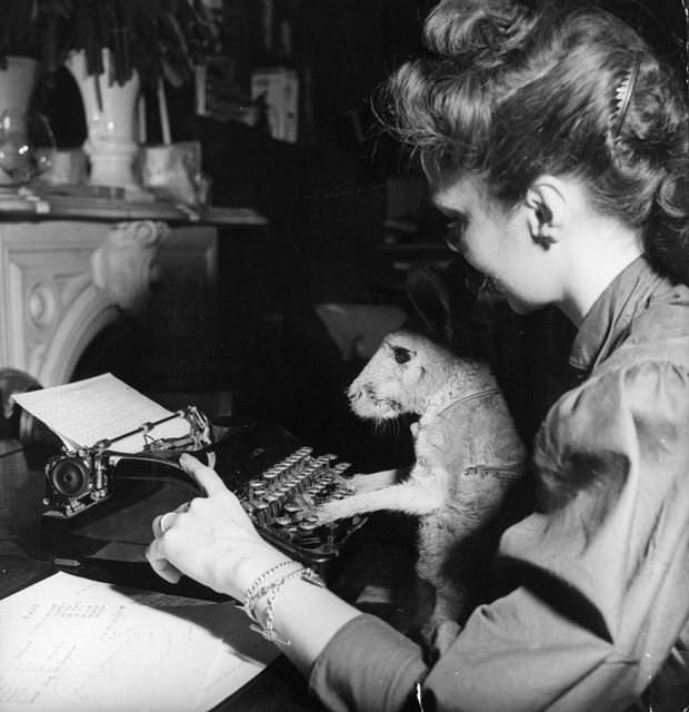 A woman teaching her kangaroo to type, 1955.