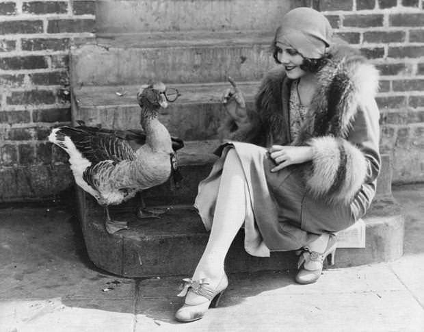 Film actress Fay Webb with her pet goose, 1925.