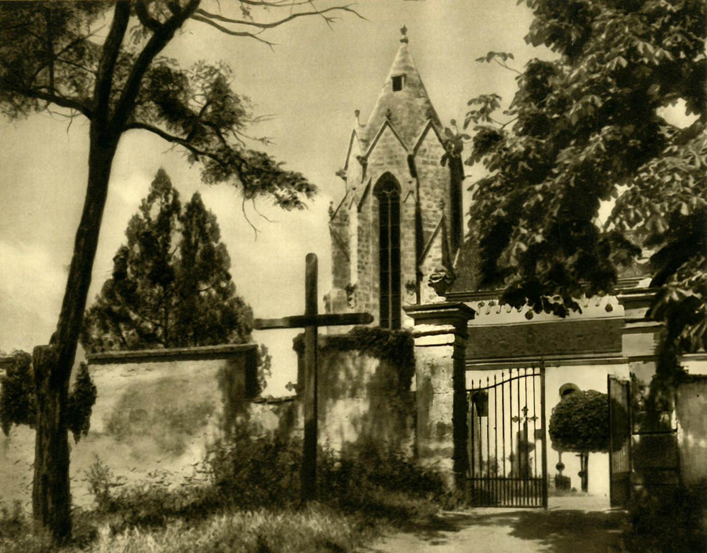 View of the churchyard and the spire of the Marienkirche, a Romanesque church dating from the 11th century, Bad Deutsch-Altenburg, Austria, 1935.