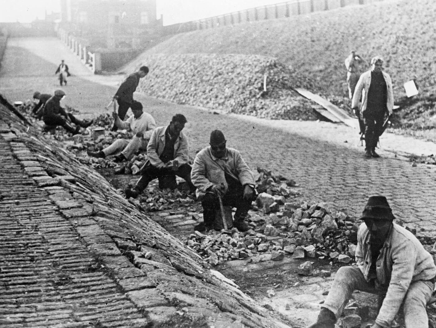 Beggars mending a road in Vienna, Austria, 1935.