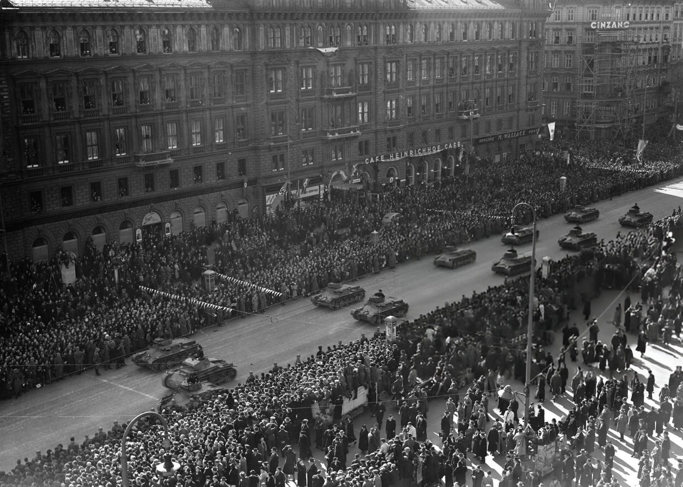 Austrian citizens giving the Nazi salute during an Anschluss parade in Vienna, 1938.