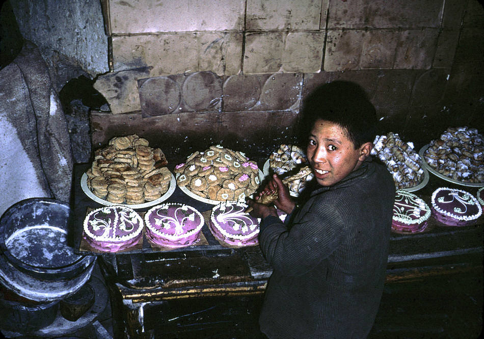 An Afghan boy decorates cakes.