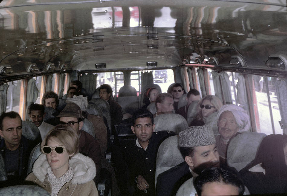 Peg Podlich, in the sun glasses, taking a family trip on a bus going from Kabul, Afghanistan to Peshawar, Pakistan.