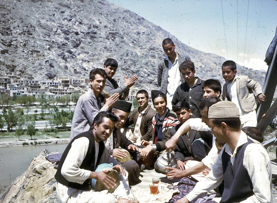 A group of young Afghans share tea and music.