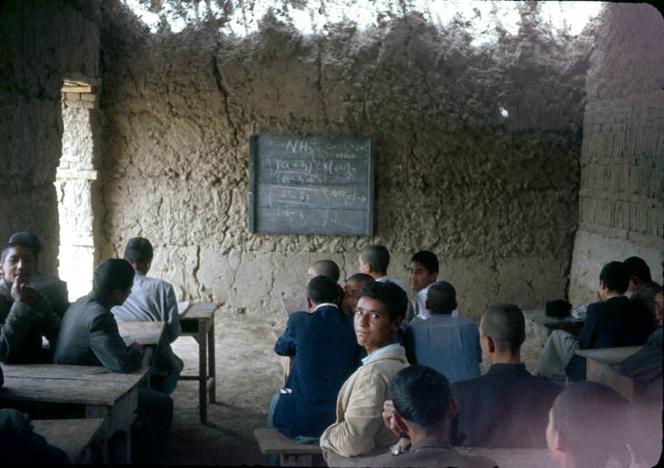 Chemistry lesson in a mud-walled classroom.