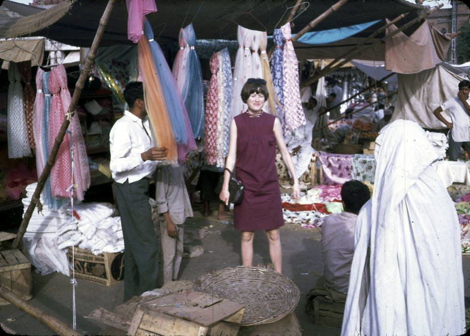 Jan Podlich on a shopping trip in Istalif. Jan in a short, sleeveless dress and the woman to the right in a chadri (burka).
