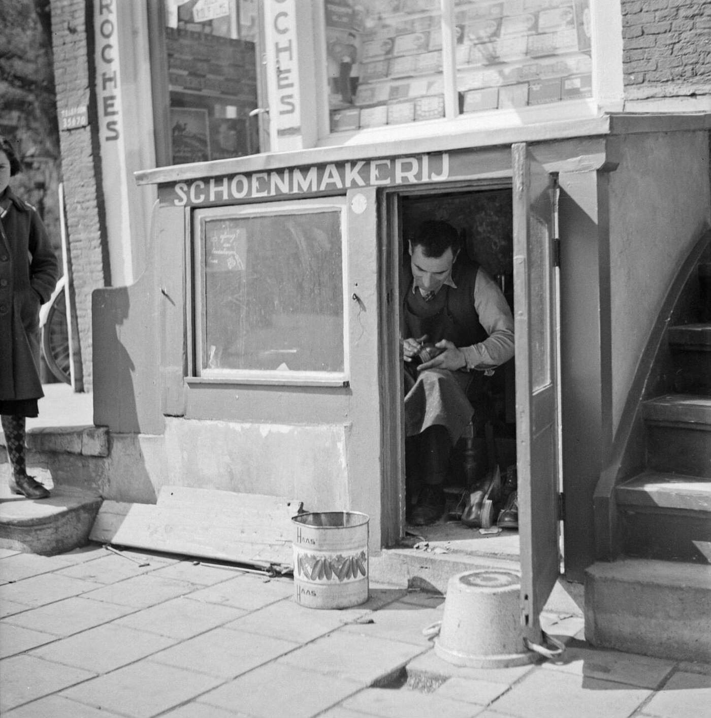 A shoemaker in his workshop, 1930s.