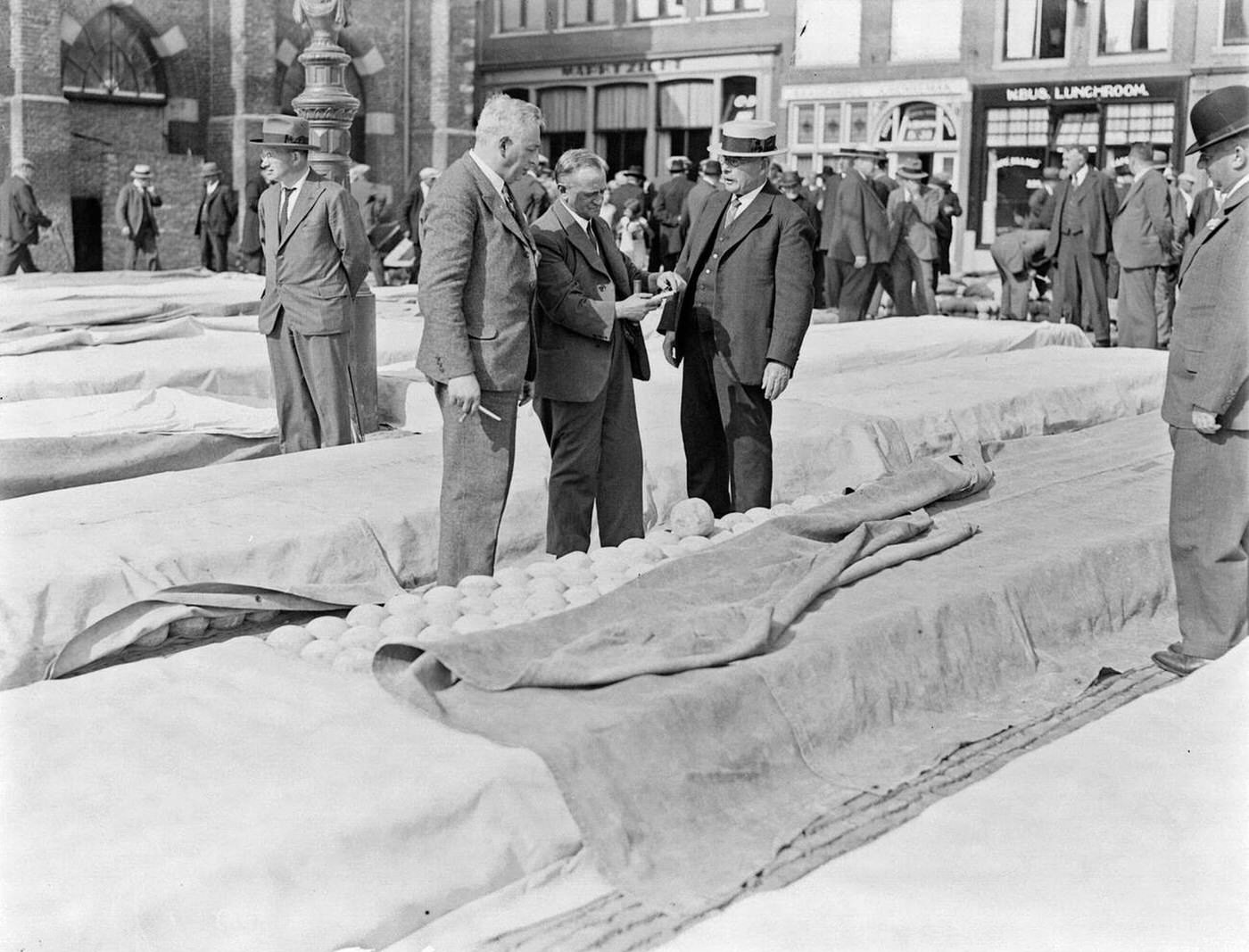 The cheese market in Alkmaar - three gentlemen tasting cheese, 1930s.