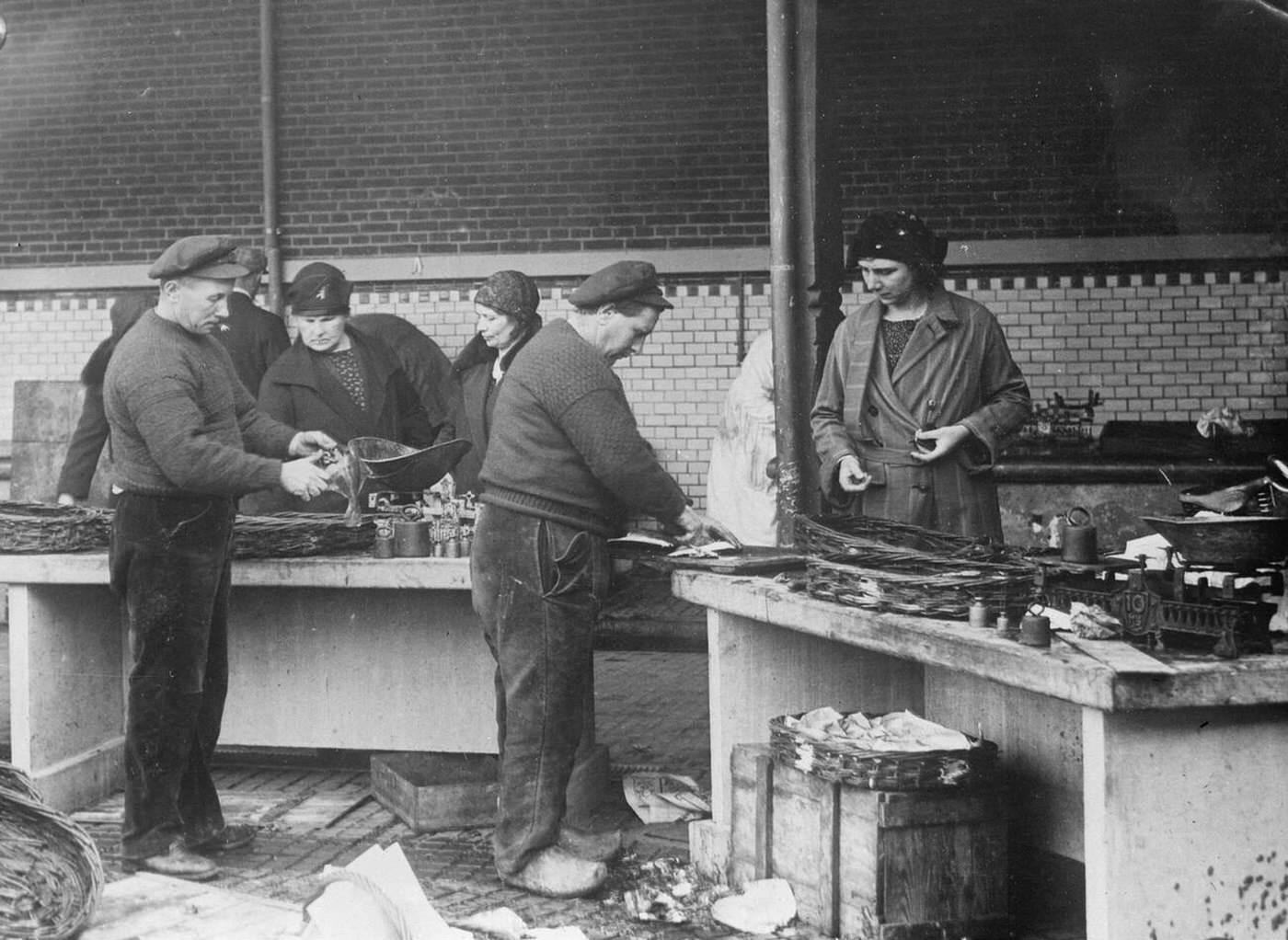 Men and women working in the fishing industry in Holland, 1932.