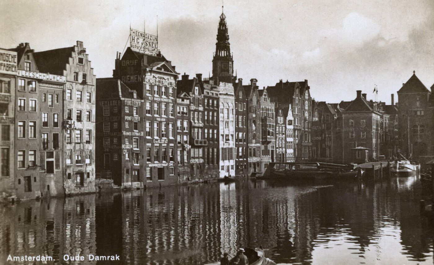 Old Damrak Canal and warehouses, Amsterdam, Holland, 1930s.