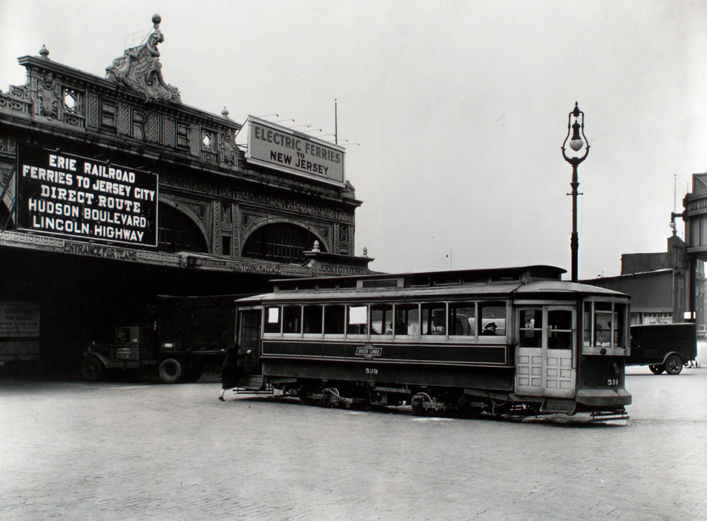 Woman boards 23rd St. trolley outside Erie Railroad Ferry terminal in New York City, 1930s.