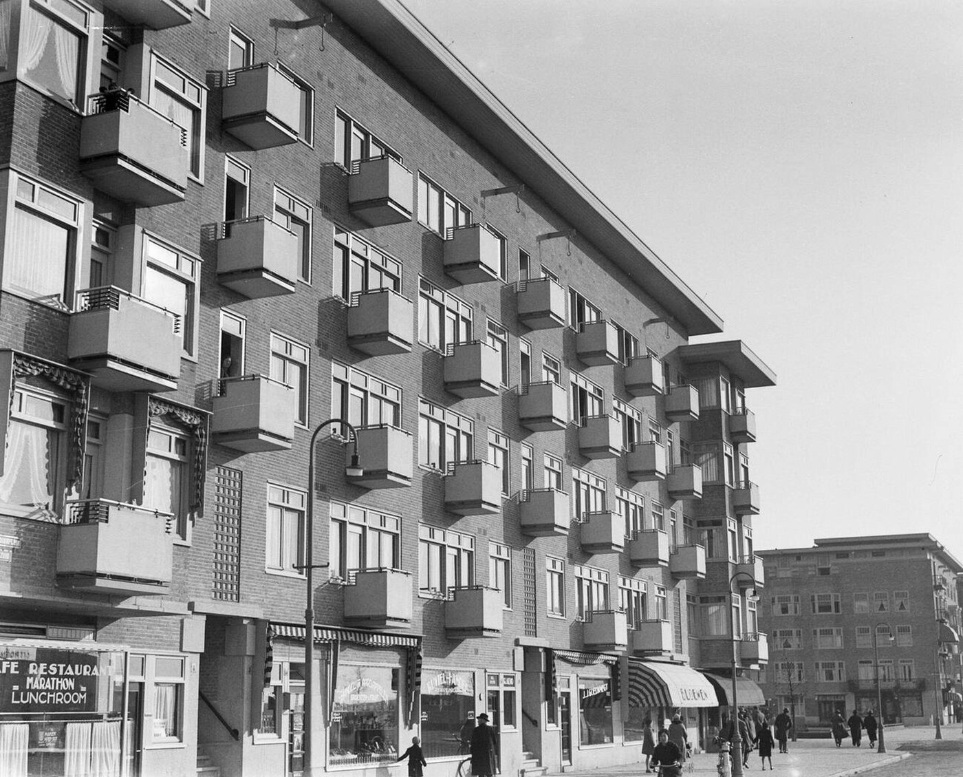 Facade view of homes and shops on Stadionplein in Amsterdam South, 1930s.
