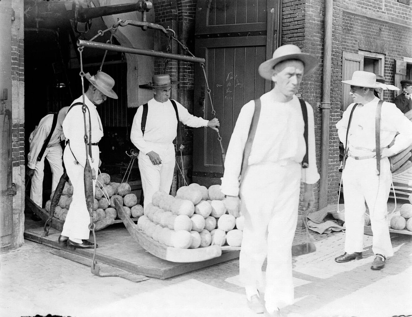 The cheese market in Alkmaar - two carriers with scales, 1930s.