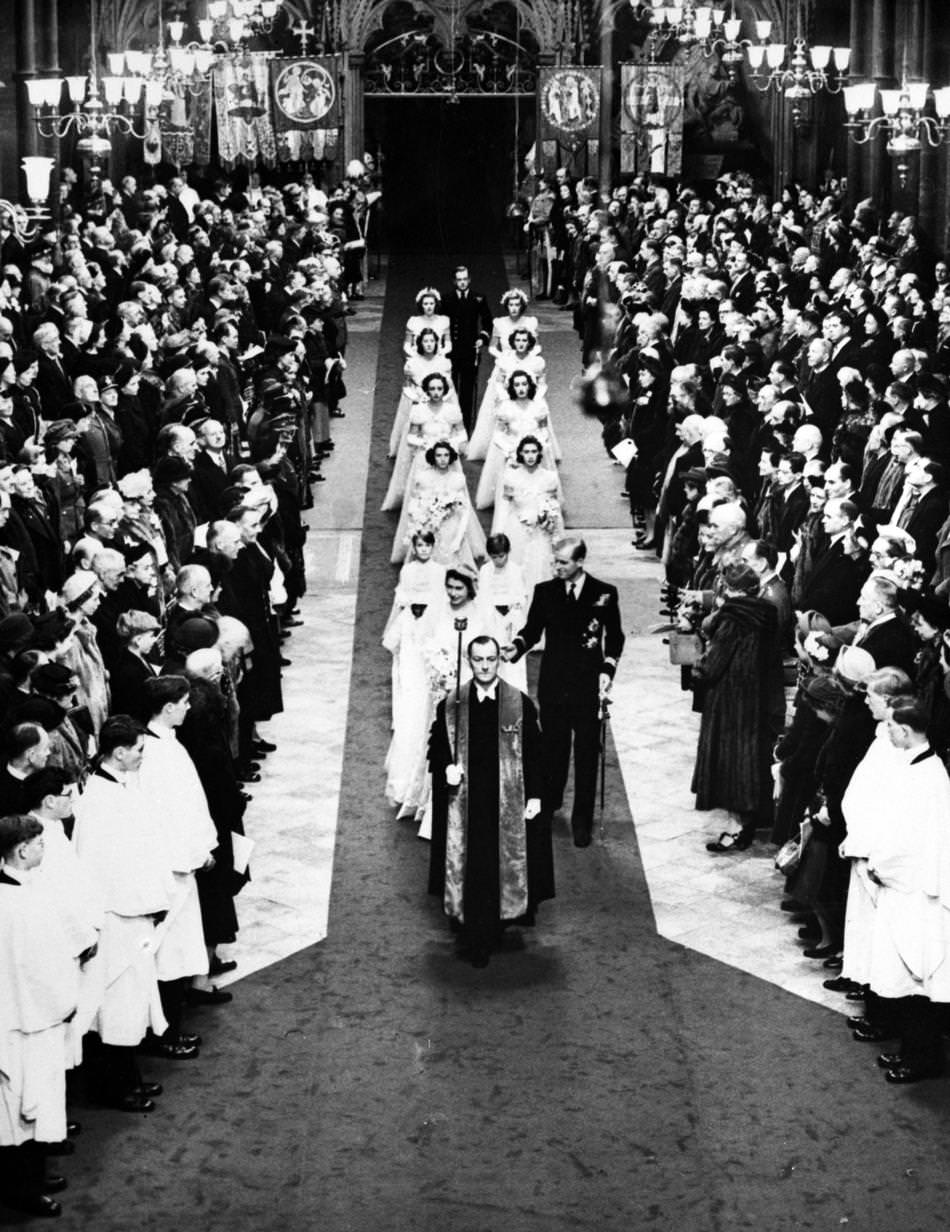 Britain's Princess Elizabeth and the Duke of Edinburgh walk down the aisle of Westminster Abbey, London, on Nov. 20, 1947, after their wedding service.