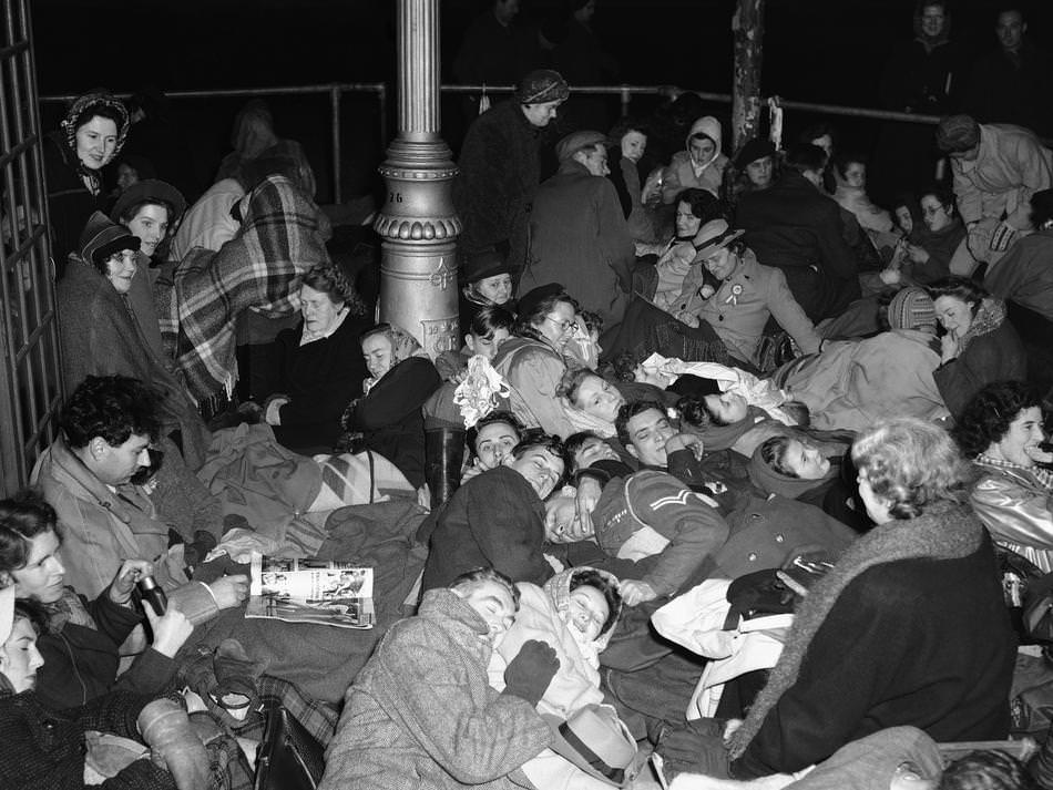 Huddled together on the pavement, opposite Westminster Abbey, London on Nov. 20, 1947, these people made sure of their positions for the Royal procession for the wedding of Princess Elizabeth and the Duke of Edinburgh.