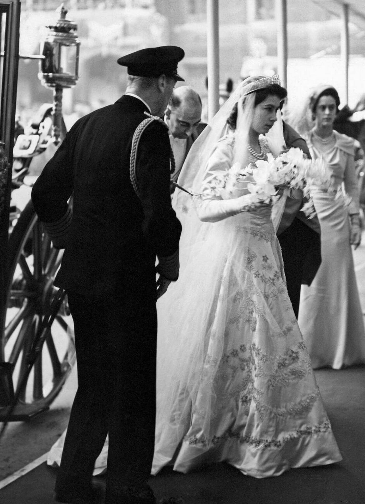 Queen Elizabeth II arrives at Westminster Abbey with her father King George VI for her wedding to Prince Philip, 1947.